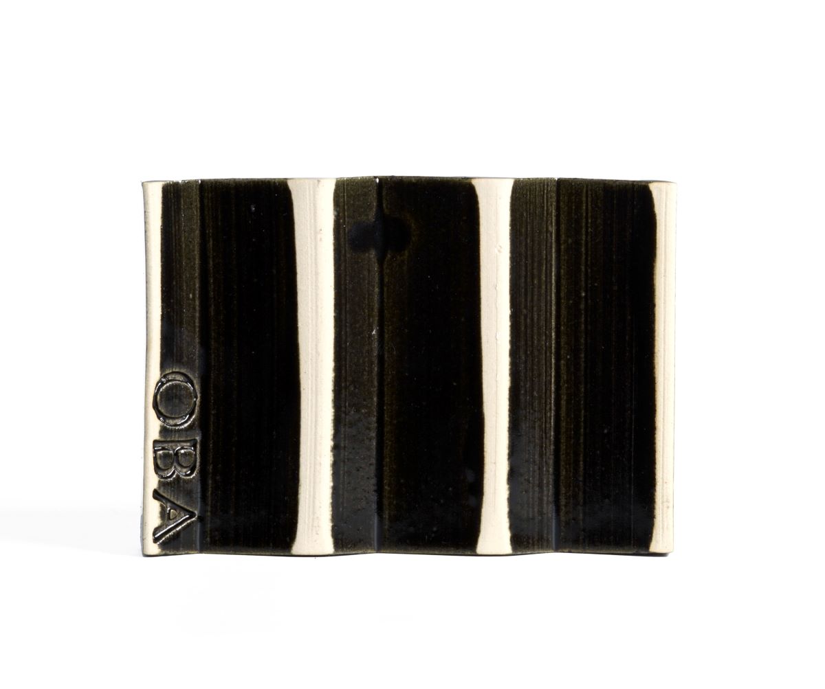 Black zig-zag shaped OBA Ceramic soap dish on the white background - underneath view.