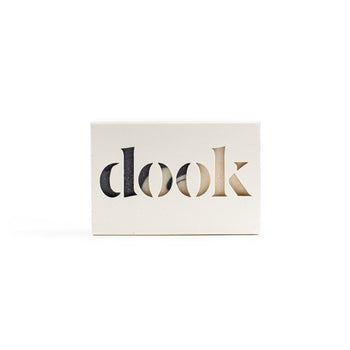 A bar of soap in a recycled paper box with the dook logo on the white background.