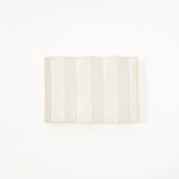 White zig-zag shaped OBA Ceramic soap dish on the white background top view.