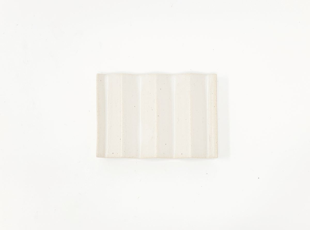 White zig-zag shaped OBA Ceramic soap dish on the white background top view.