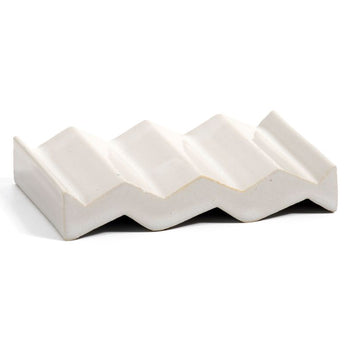 White zig-zag shaped OBA Ceramic soap dish on the white background side view.