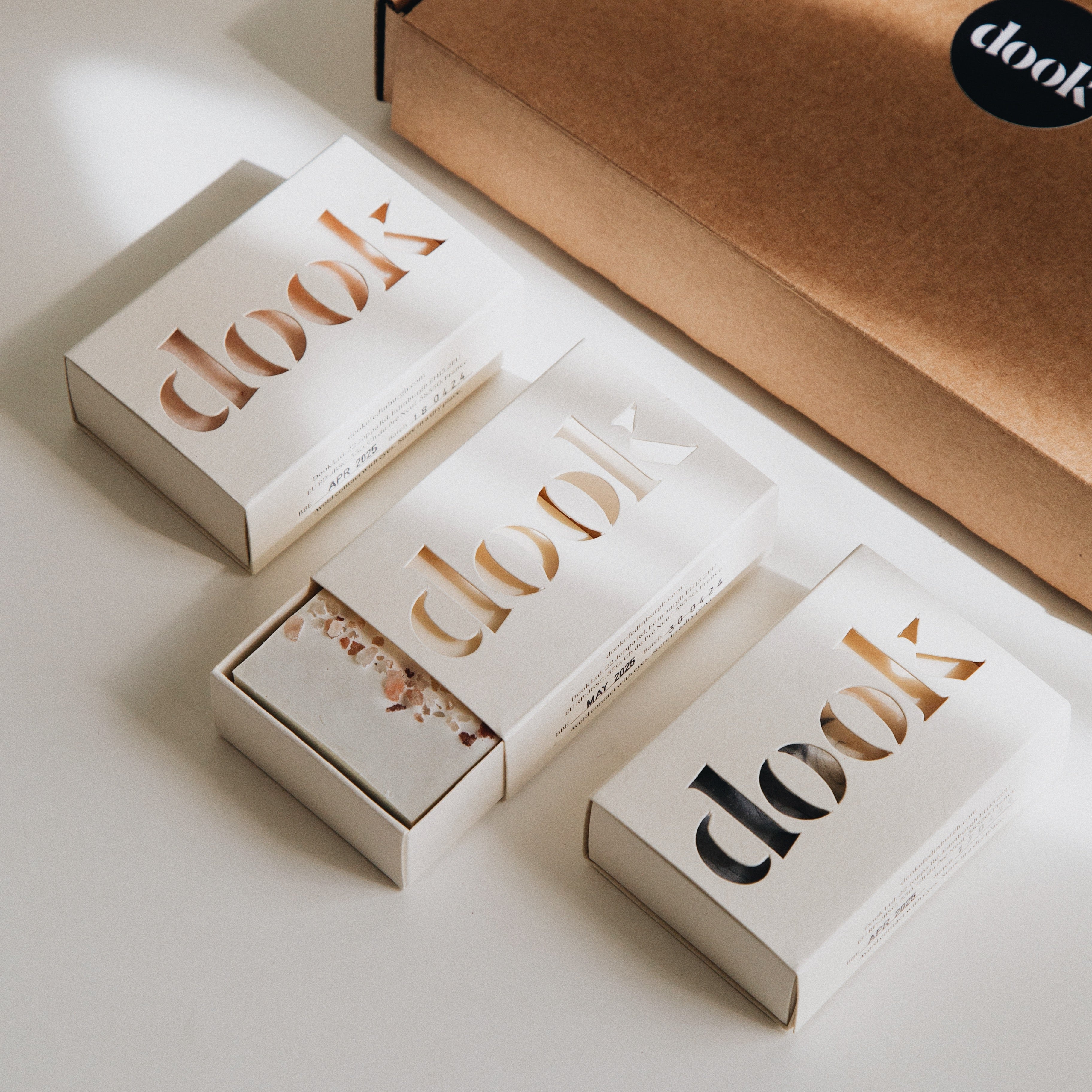 An arrangement of soaps next to a brown box.