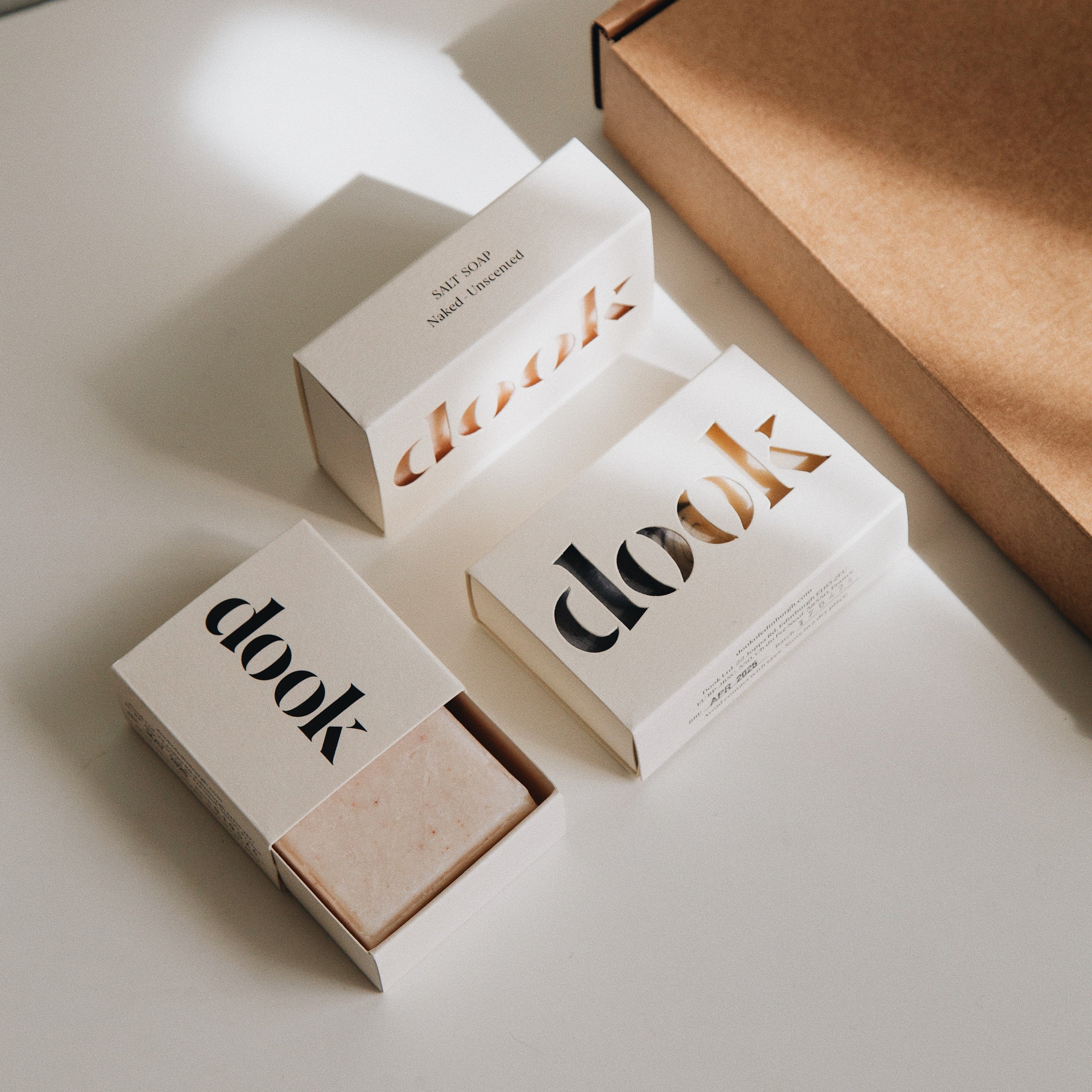 Subscription box offer of two soaps and a shampoo next to a brown box.