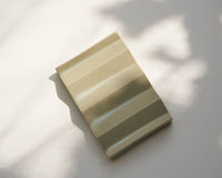 Light green zig-zag shaped OBA Ceramic soap dish on the white background top view.