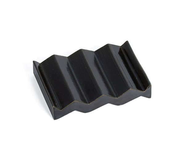 Black zig-zag shaped OBA Ceramic soap dish on the white background top view.