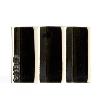 Black zig-zag shaped OBA Ceramic soap dish on the white background - underneath view.