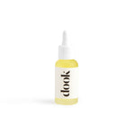 Small bottle of conditioning oil with pipette. Labelled with black logo on white sticker. White background.