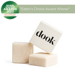 Shampoo square bars on white background. Two unboxed bars and one in a white box with black dook logo. Beauty shortlist awards 2023 editor's choice winner title badge on a green background.