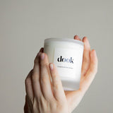 Dook's candle being held in two hands.