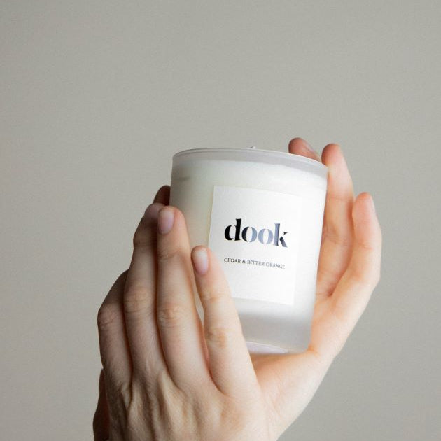 Dook's candle being held in two hands.