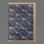 A dark blue greeting card with white sea waves pattern.