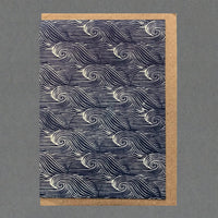 A dark blue greeting card with white sea waves pattern.