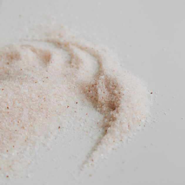 Handblended bath salts on the white surface.