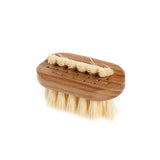 A smaller, wash bag size wooden nail brush on the white background.