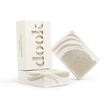 Three handmade bar soaps with green and creamy white pattern on the white background.