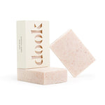 Three bars of natural soap in a composition. Two unboxed soaps are pink with darker pink spots of Himalayan salt and one bar in a box with the dook logo. 