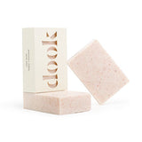 Three bars of natural soap in a composition. Two unboxed soaps are pink with darker pink spots of Himalayan salt and one bar in a box with the dook logo. 