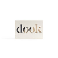 A bar of soap in a recycled paper box with the dook logo on the white background.