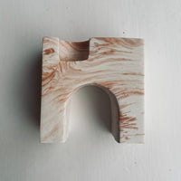 Marbled terracotta and white candle holder on the white background.