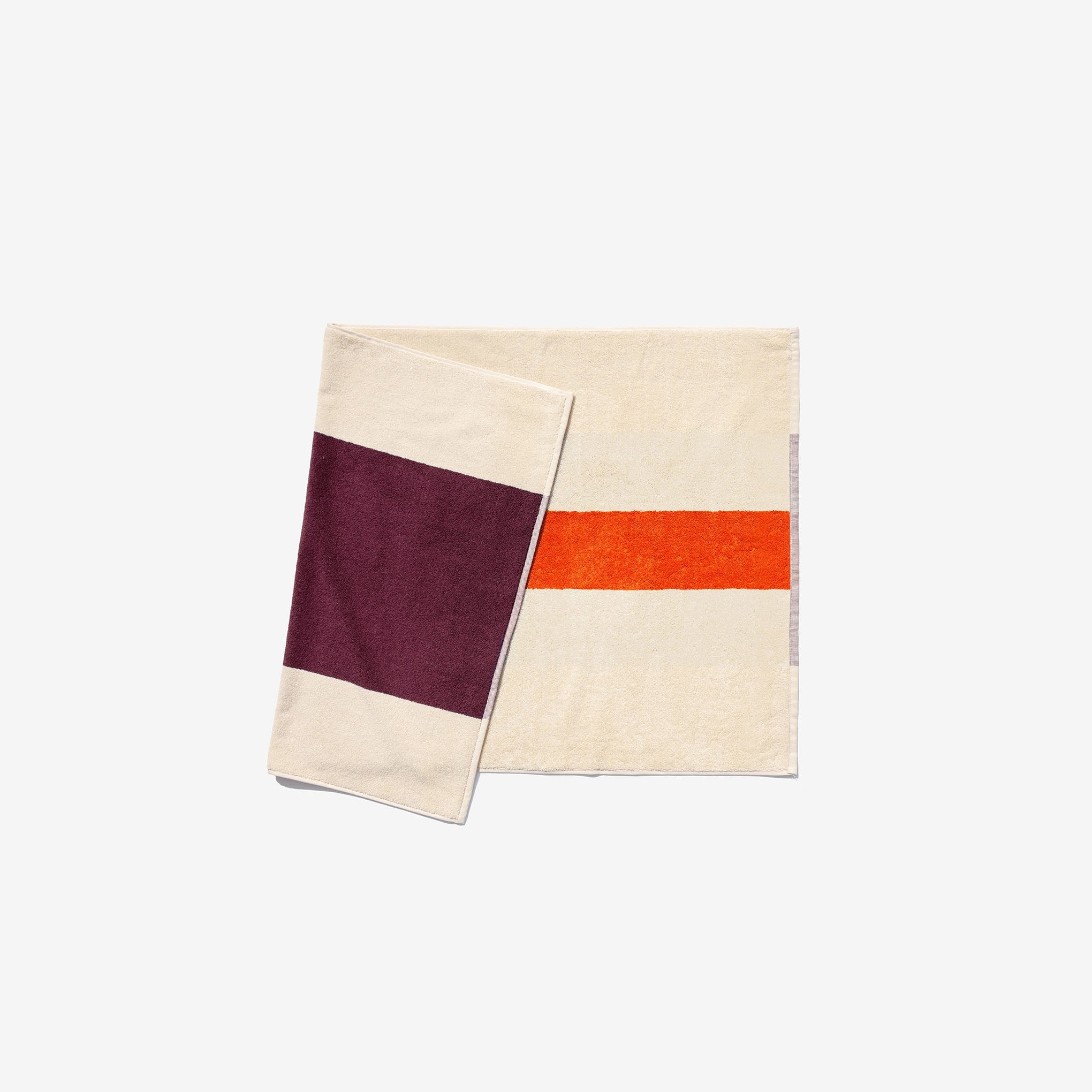 A bath mat with a bordeaux and orange color scheme, featuring a hanging loop on one end.