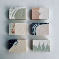 Six handmade dook soaps lying flat and exposing different patterns of each soaps.