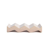 Light pink zig-zag shaped OBA Ceramic soap dish on the white background side view.
