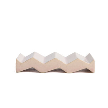Light pink zig-zag shaped OBA Ceramic soap dish on the white background side view.