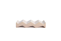 Light pink zig-zag shaped OBA Ceramic soap dish on the white background side view.