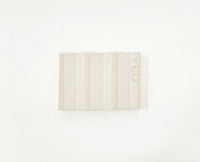 White zig-zag shaped OBA Ceramic soap dish on the white background - underneath view.