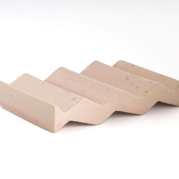 Rose light pink zig-zag shaped OBA Ceramic soap dish on the white background side angle view.