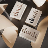 The boxed dook's soaps with pieces of creamy paper creating an arty still life photo arrangement.