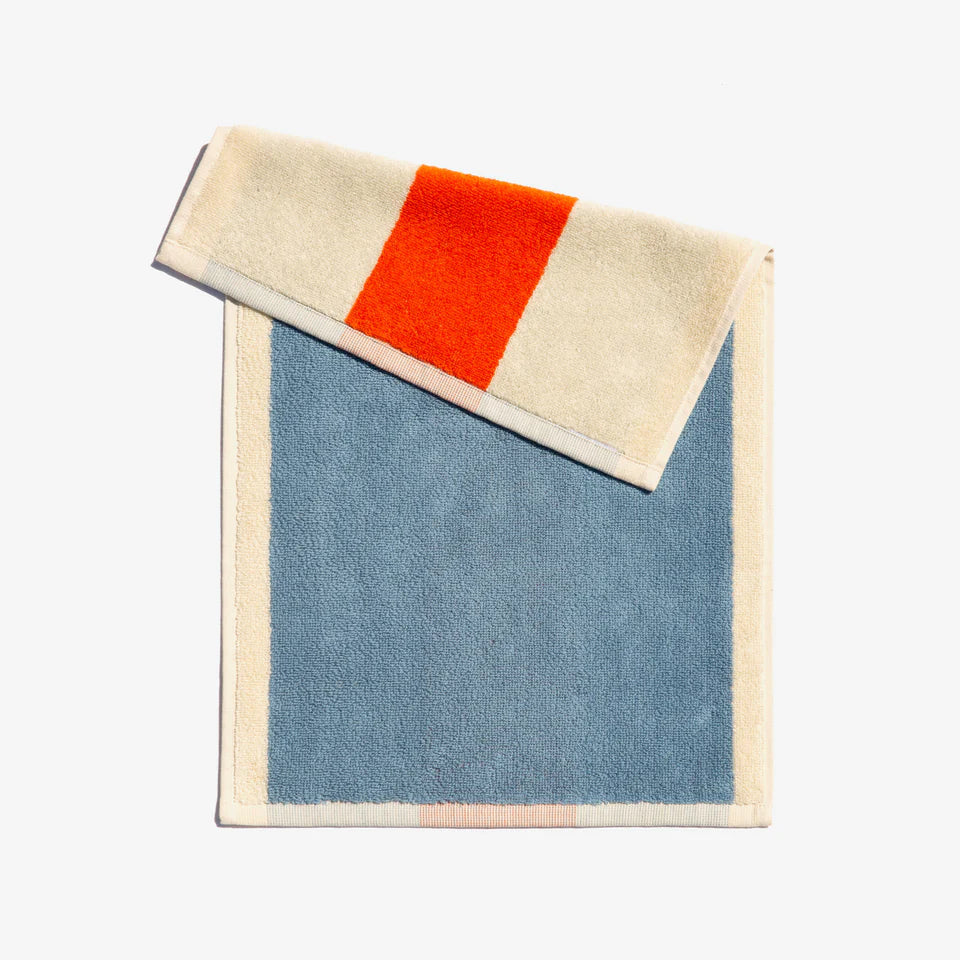 A folded face towel with sky blue and orange horizontal stripes, with a loop for hanging.